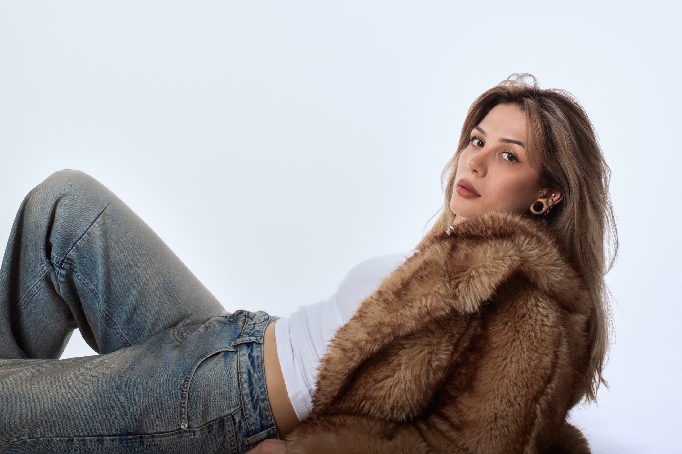 Aleyna Erkoc Atesli in a brown faux fur coat, looking over her shoulder